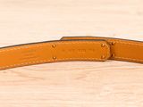the belt is made out of leather and has a metal buckle