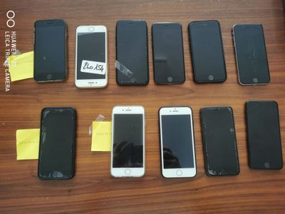 several cell phones are lined up in a row on a table