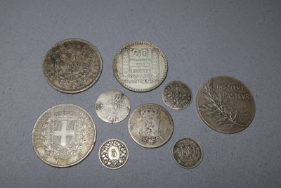 several silver coins sitting on a table next to each other