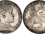 a silver coin with an image of a woman and a lion on it