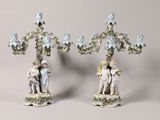 pair of porcelain figurines of a boy and a girl on a tree