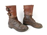 pair of brown leather boots with buckles on a white background