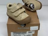baby ' s shoes in a box on a white surface