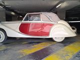 a red and white car parked in a parking garage