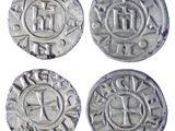 four silver coins with the names of different countries on them