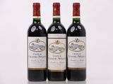 trois bouteilles de vin rouge posées l'une à côté de l'autre sur une surface blanche