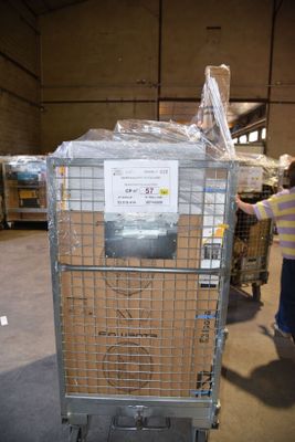 a woman standing next to a cart in a warehouse