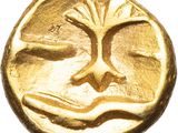 a close up of a gold coin with a tree on it