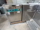 two stainless steel ovens that are sitting in a room