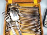 a wooden box with silverware in it on a table