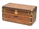 a brown and tan chest with gold hardware on it