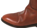 brown leather boots on a white surface with a white background