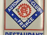 an image of a restaurant sign on a white wall with a red and blue design