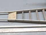 a ladder that is sitting on the floor next to some other items