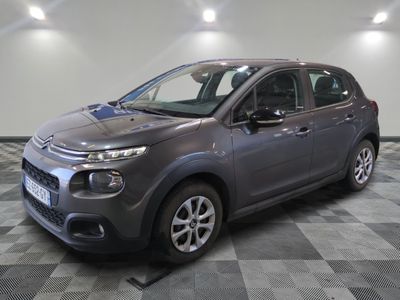 the grey citrole is parked on a checkered tile floor