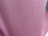 a close up of a person wearing a pink shirt