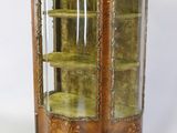 an antique display cabinet with a glass door and gold trimmings