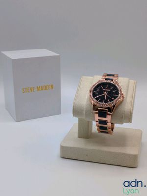 a close up of a watch on a display with a box in the background