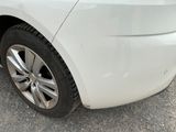 a white car that is parked on the side of the road