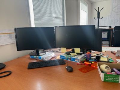 two computer monitors sitting on a desk next to a keyboard and mouse