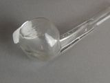 a glass pipe sitting on a table with a spoon in it