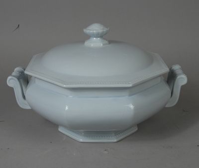 a white bowl with a lid on a table