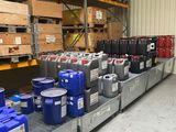 many containers and containers of different colors on the shelves