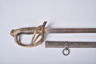 une vieille épée et une clé posées sur une surface blanche