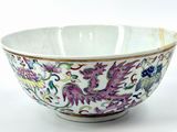 a white bowl with a dragon design on it
