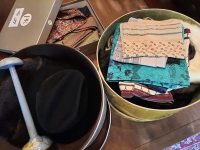 two buckets of clothes and a hat on a table