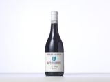 a bottle of red wine sitting on top of a table