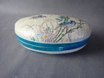 a white and blue box with flowers and birds on it