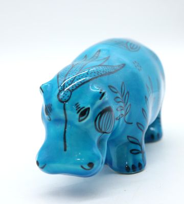 a blue elephant figurine sitting on a white surface
