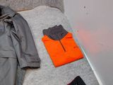 a pile of clothes and a jacket on the floor