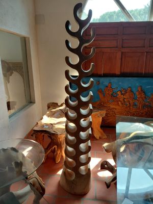 a tall vase that is sitting on a table in a room