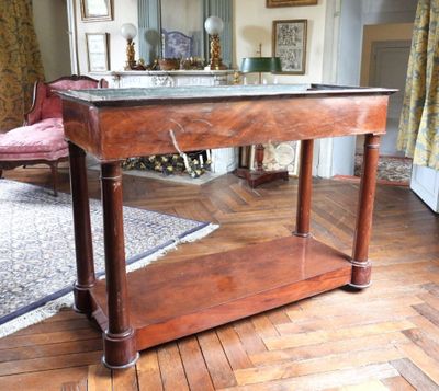 une table en bois avec un plateau en verre dans un salon