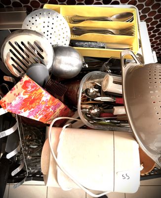 many kitchen utensils and other kitchen items in a dishwasher
