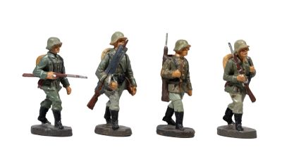 three figurines of men in uniforms with rifles and helmets