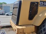 a large yellow tractor parked in a parking lot
