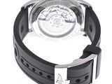 the watch is black and silver with a black rubber band