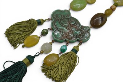 a long necklace with tassels and beads on it