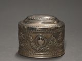 an antique silver plated box with a lid on a gray surface