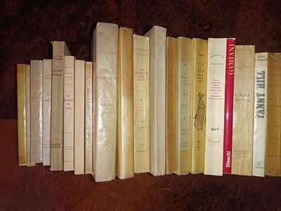 several books are stacked on top of each other on a table