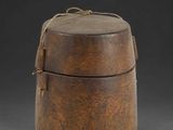 an old wooden box with a rope around it