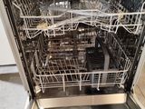 a dishwasher in the middle of a kitchen with a lot of dishes inside of it