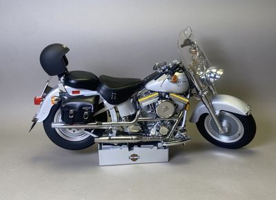 a white motorcycle with a black helmet on it