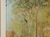 a painting on the wall of a building with a bird flying by it