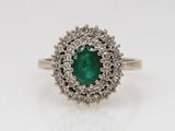 an emerald and diamond cluster ring