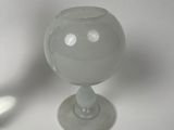 two glass vases sitting next to each other on a table