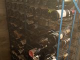 many bottles of wine on a rack in a room